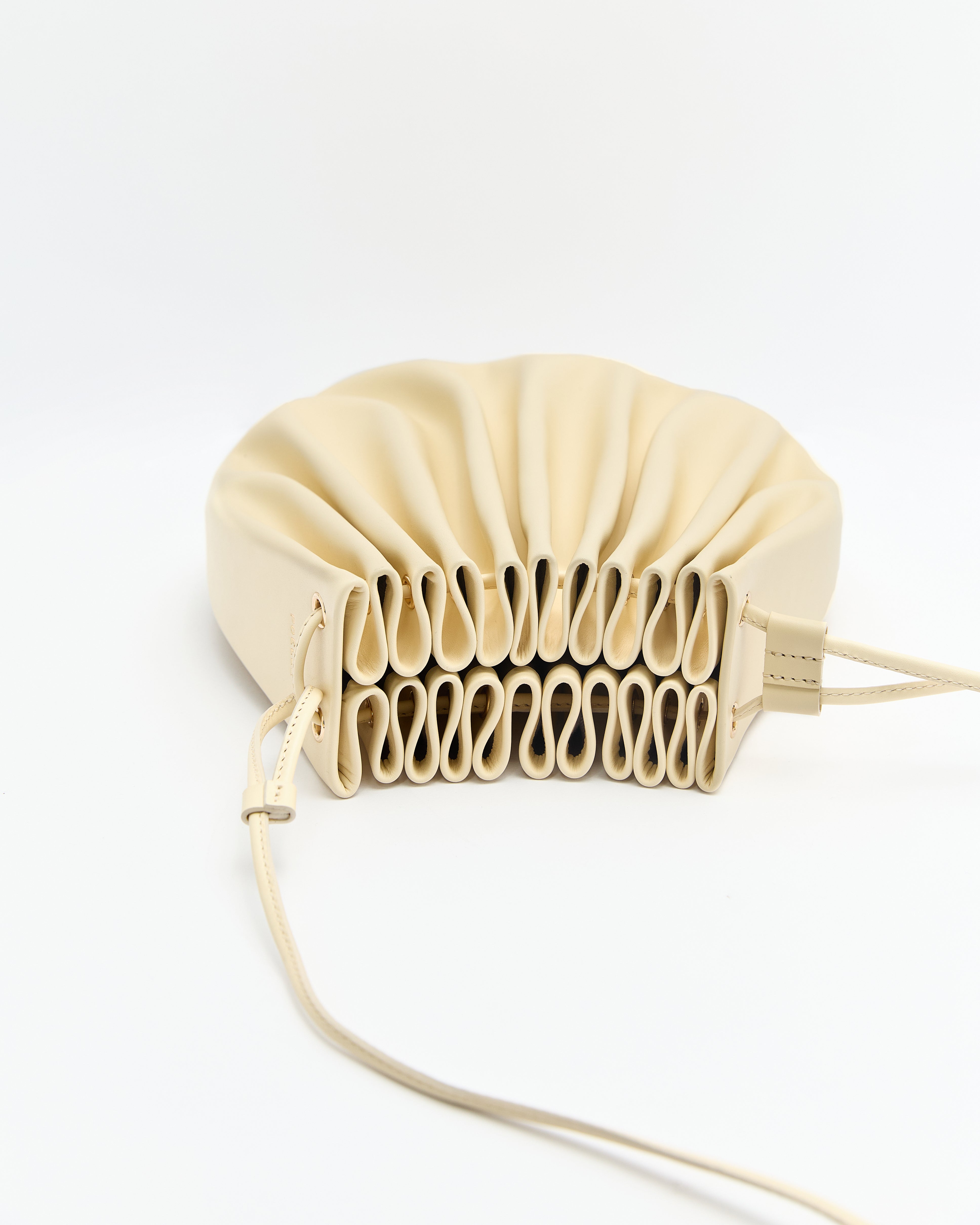 Poelle Atelier cream-colored luxury summer crossbody bag with unique pleated design and slim strap