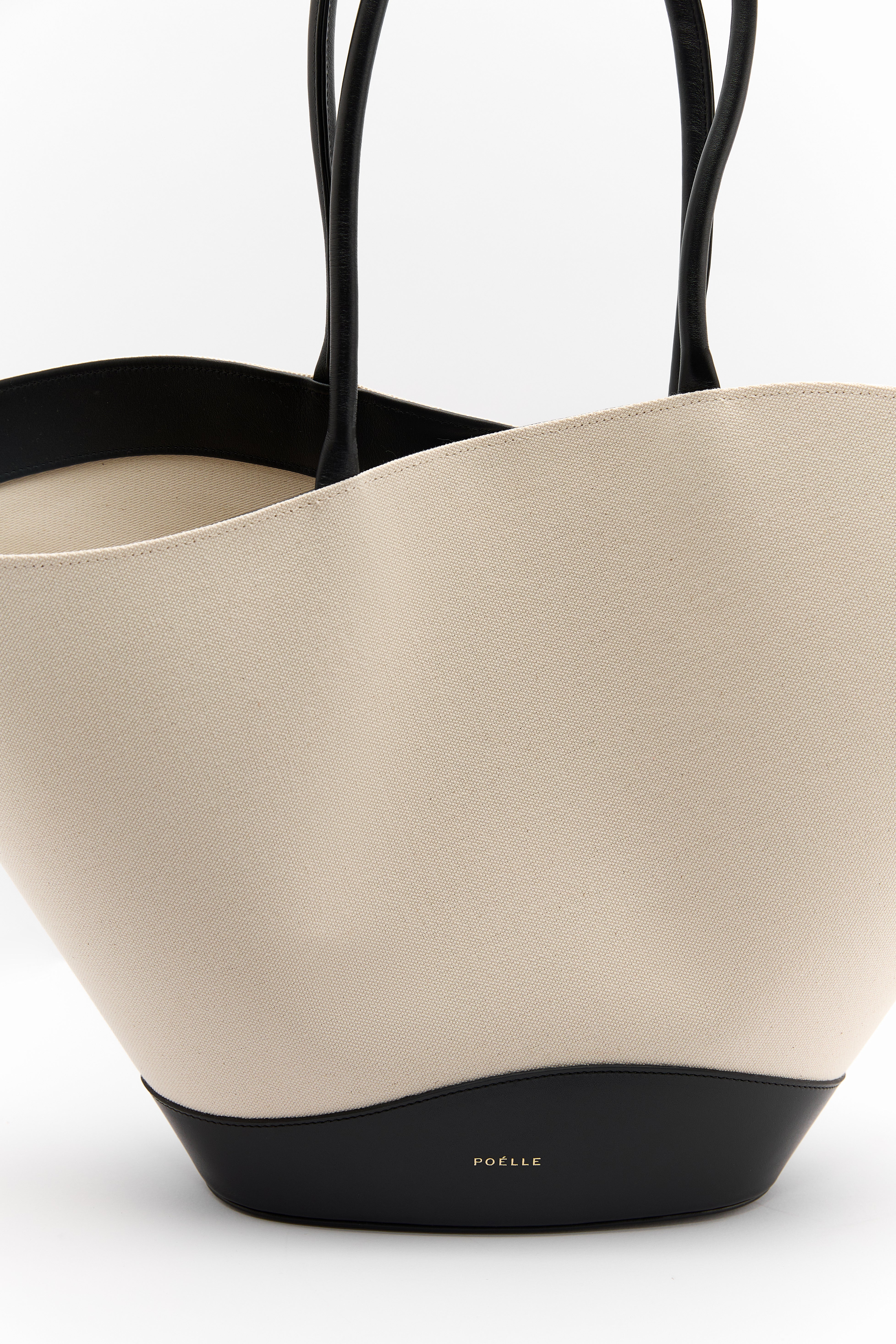 Poelle Atelier luxury summer leather bag in beige with black handles and base