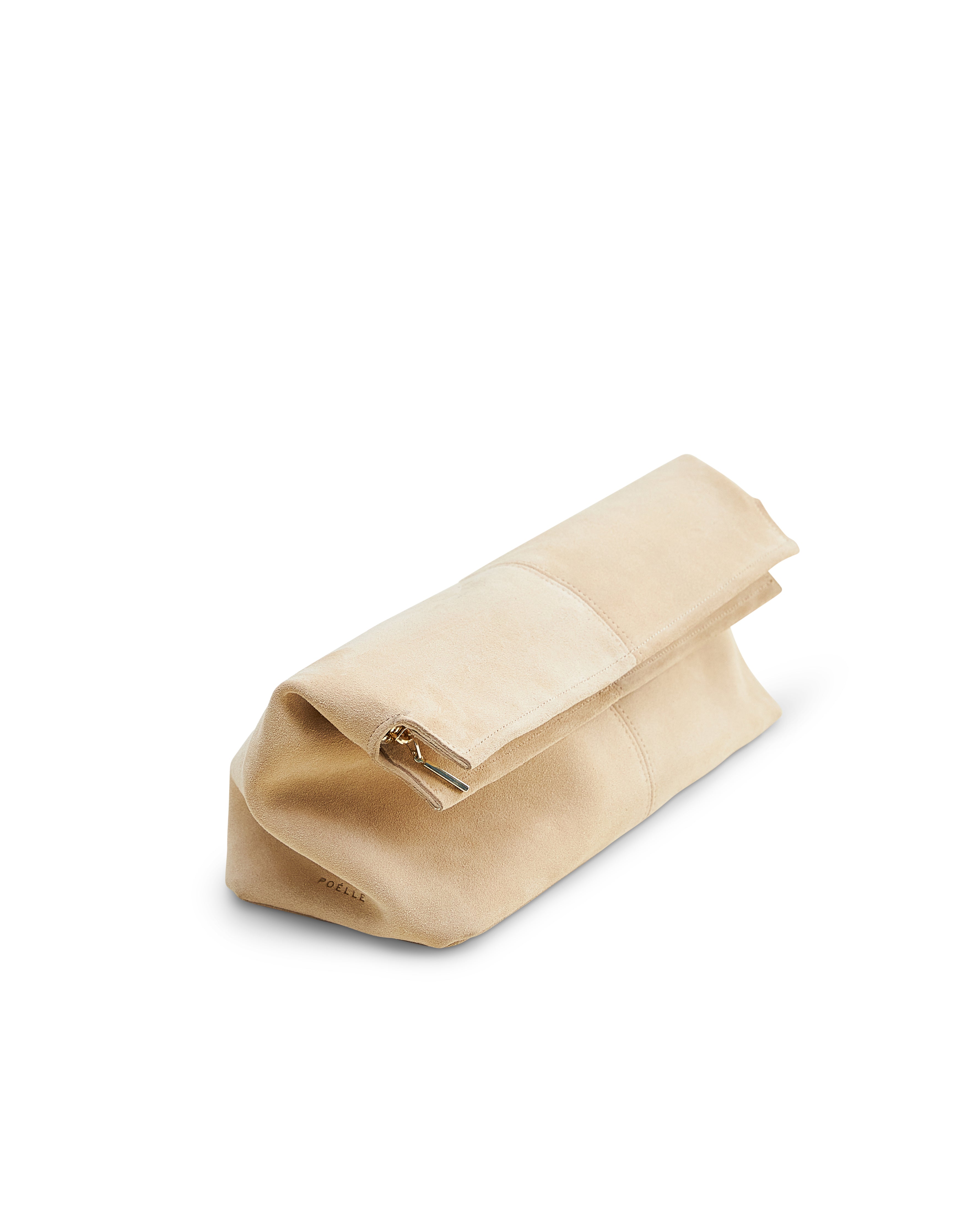 Beige luxury suede clutch bag with fold-over design and gold zipper by Poelle Atelier