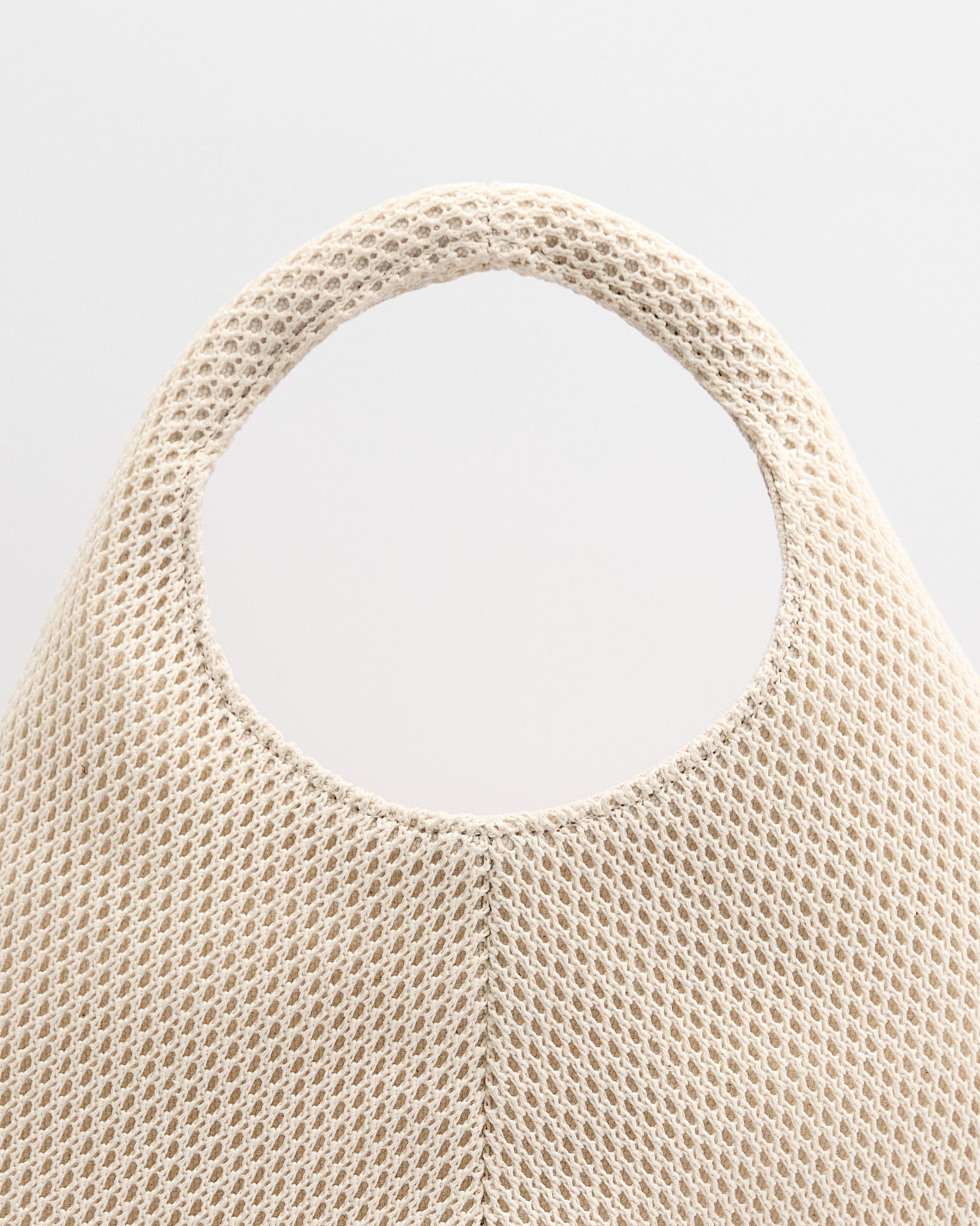Poelle Atelier luxury minimalist summer bag in beige mesh fabric with circular handle