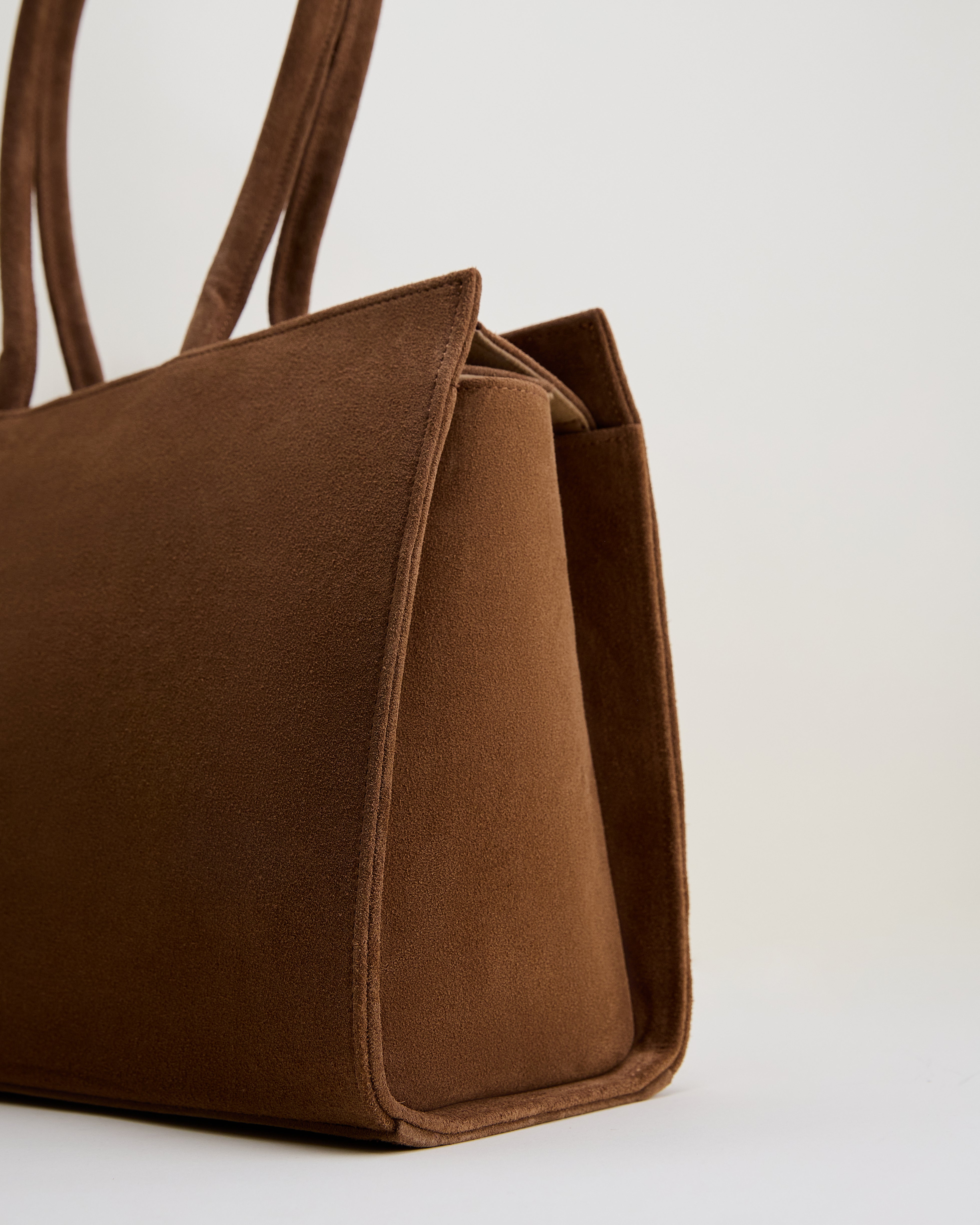 Poelle Atelier luxury suede tote bag in rich brown with elegant smooth texture and structured design