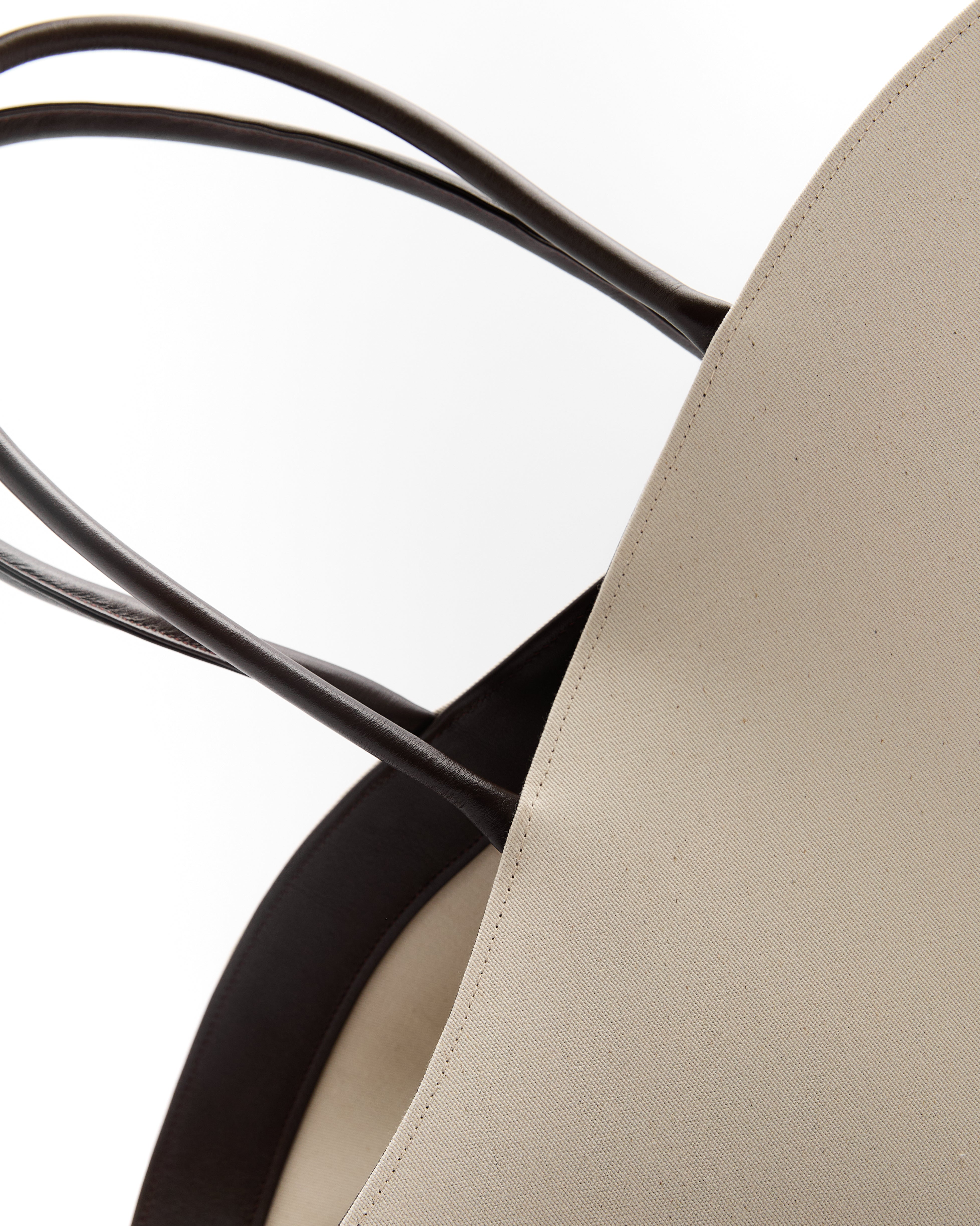 Close-up of luxury summer leather bag straps and smooth exterior by Poelle Atelier