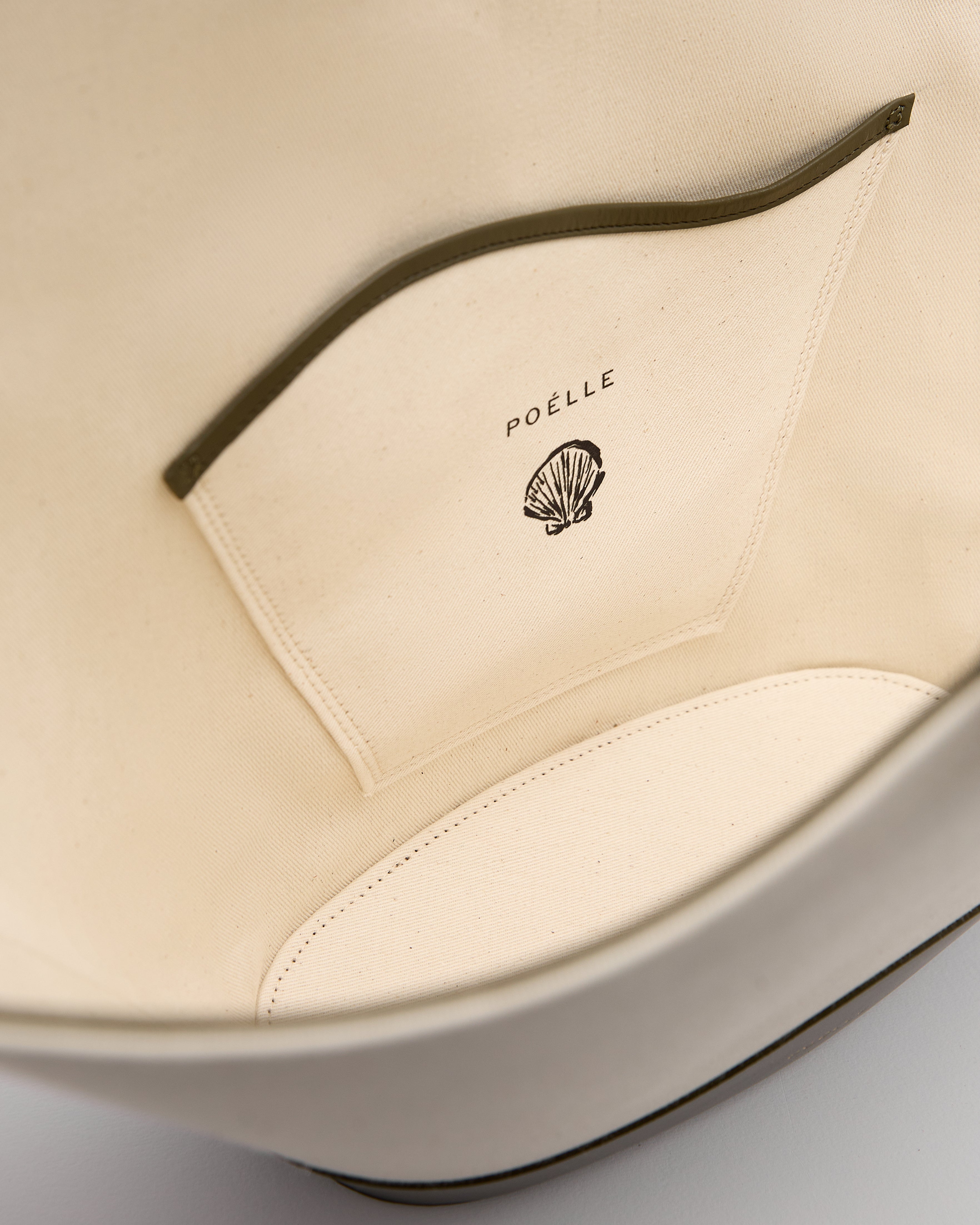 Interior view of Poelle Atelier luxury summer leather bag with branded inner pocket and soft lining