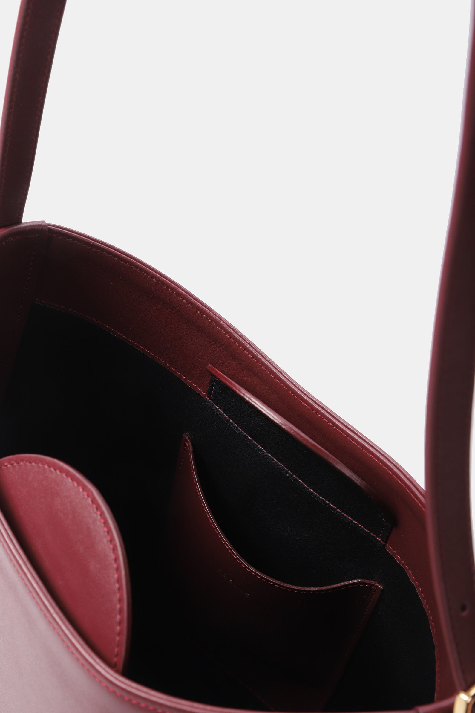 Interior view of Poelle Atelier luxury minimalist sculptural bag showing smooth leather and inner pockets