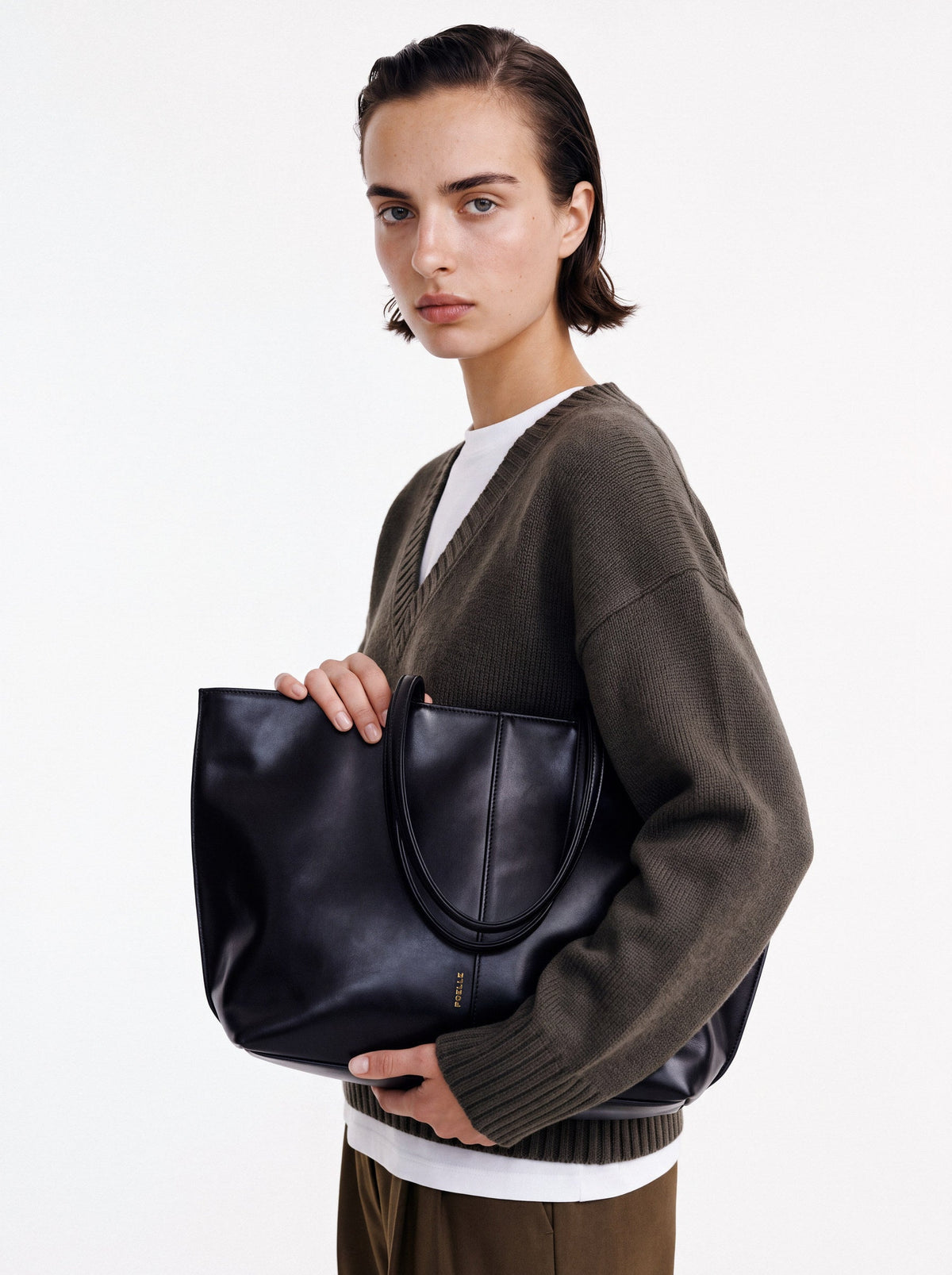 Jane Tote in black, carried in the hand