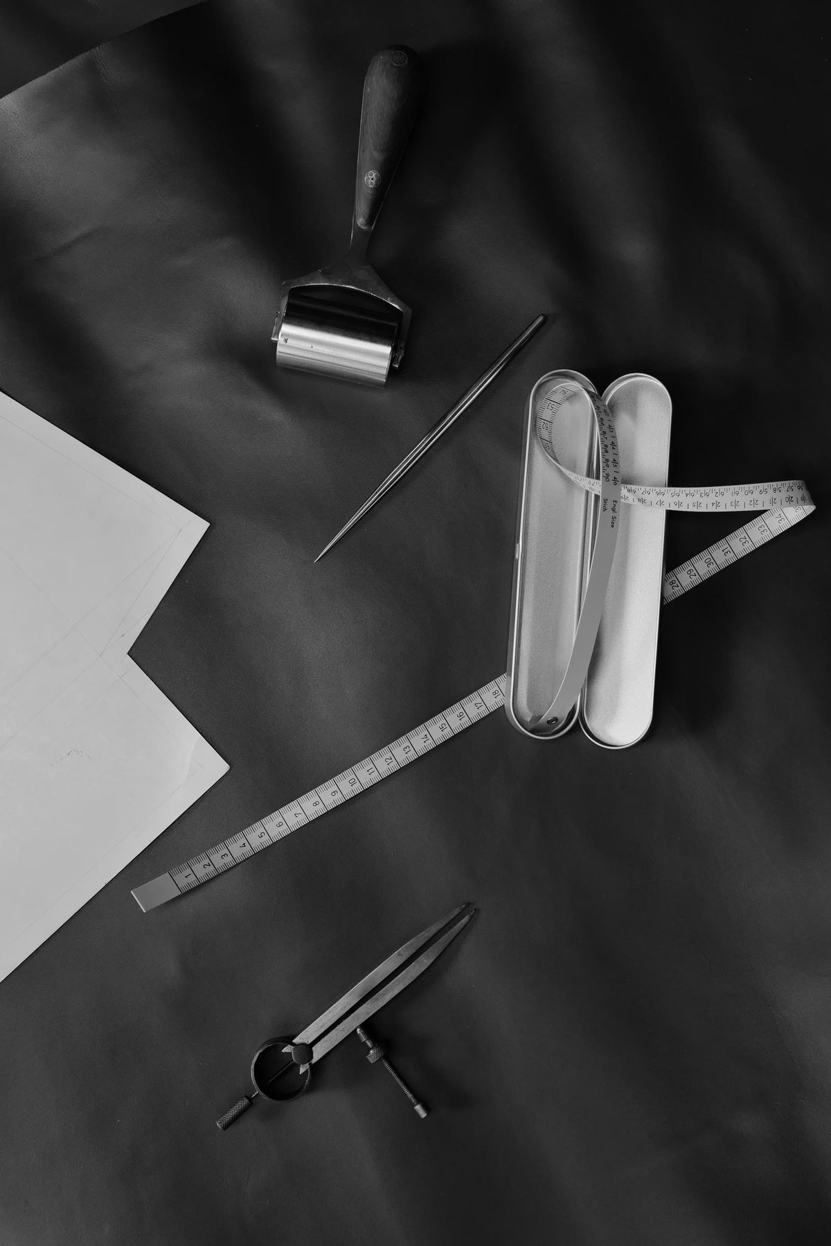 Atelier tools: awl, ruler, compass and paper patterns