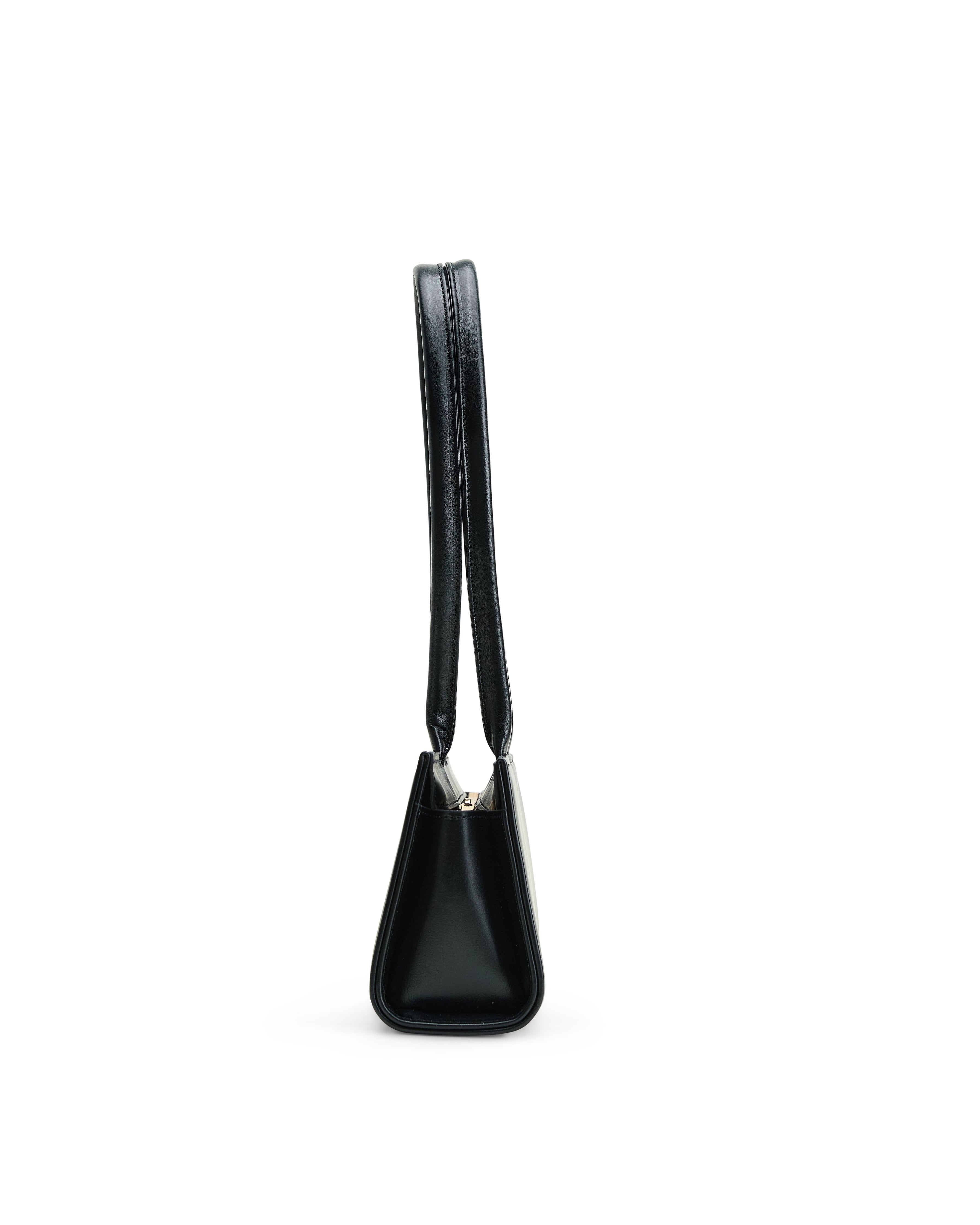 Side view of luxury black leather handbag with sleek design and long strap by Poelle Atelier