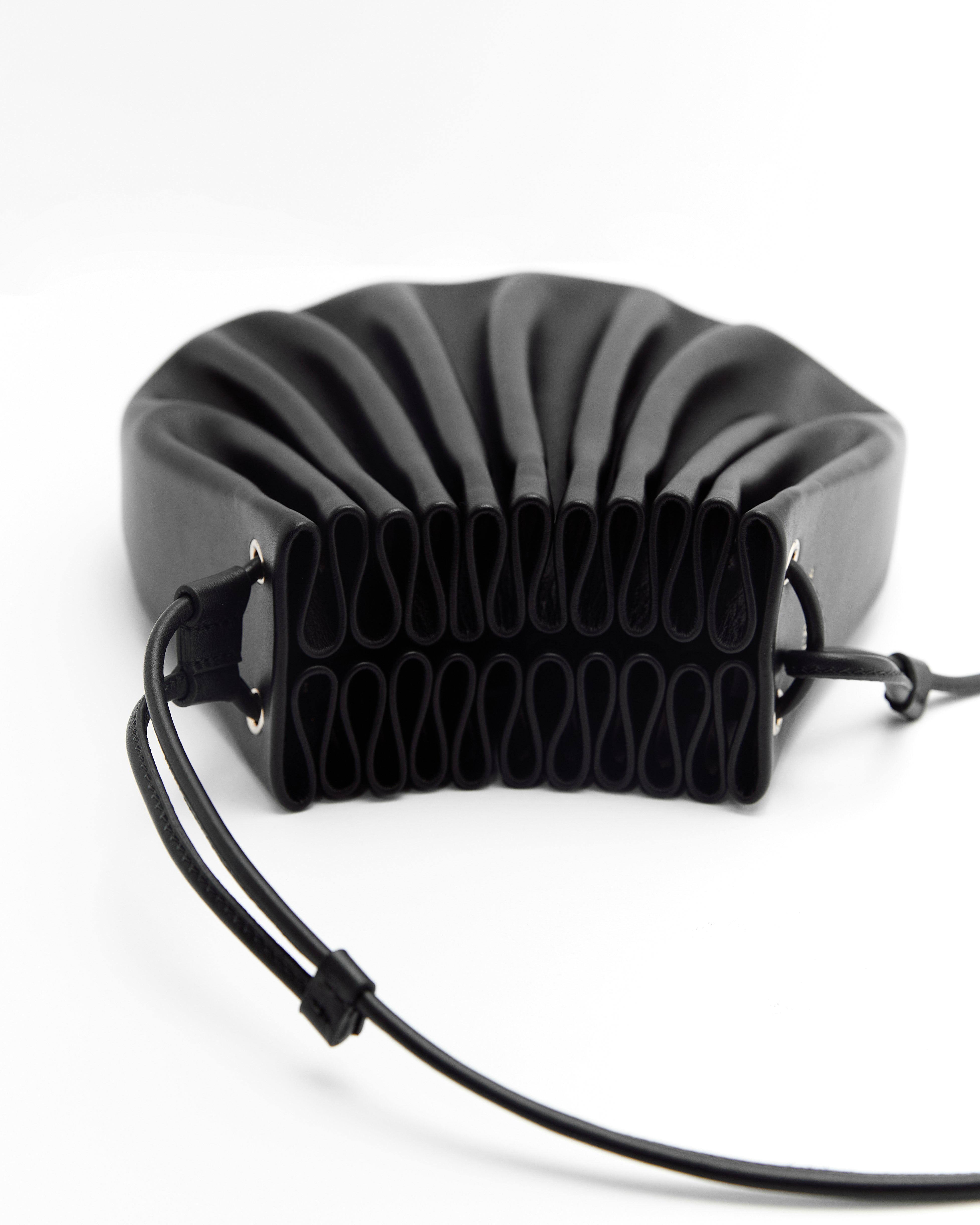 Poelle Atelier luxury summer crossbody bag in black with unique pleated design and adjustable strap