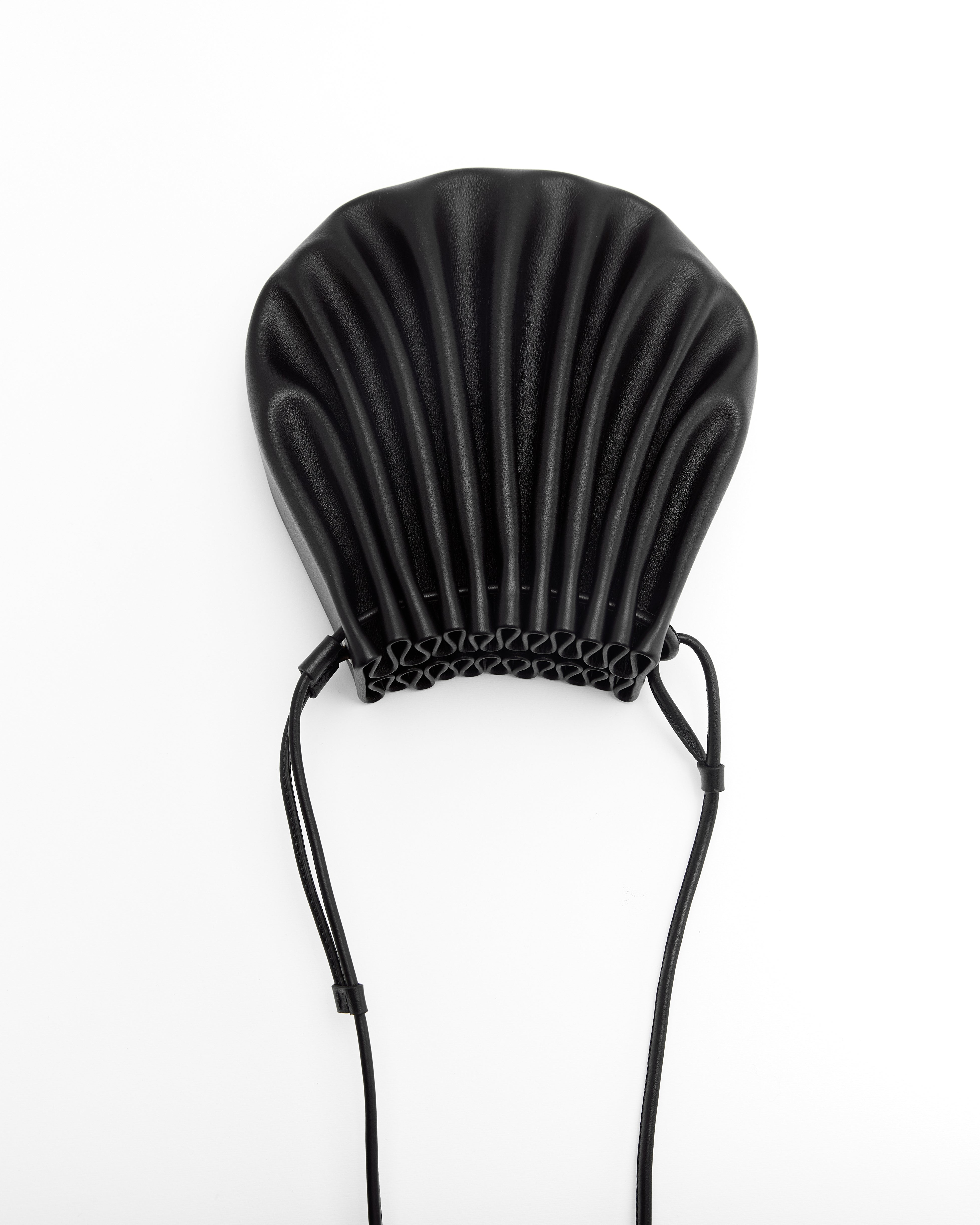 Poelle Atelier luxury summer crossbody bag in black with shell-inspired design and adjustable strap