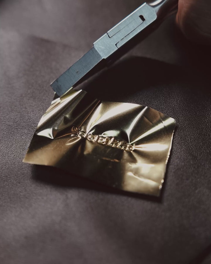 Hot-stamping the Poelle mark in gold foil